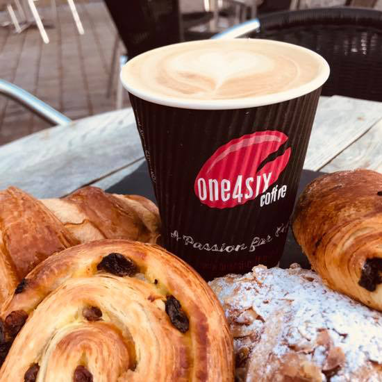 Takeaway cup of coffee with pastries
