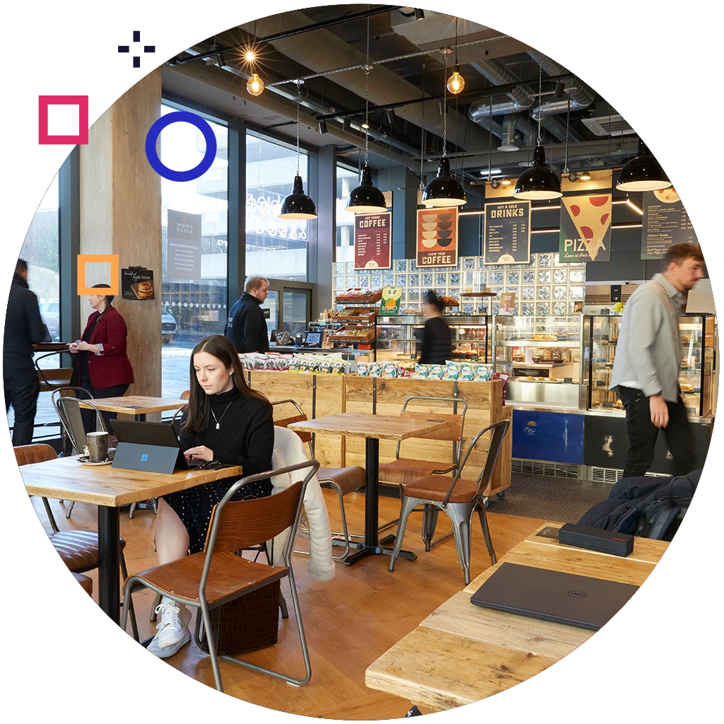 Modern museum café with visitors ordering and dining, supported by digital menus and pointOne hospitality tech