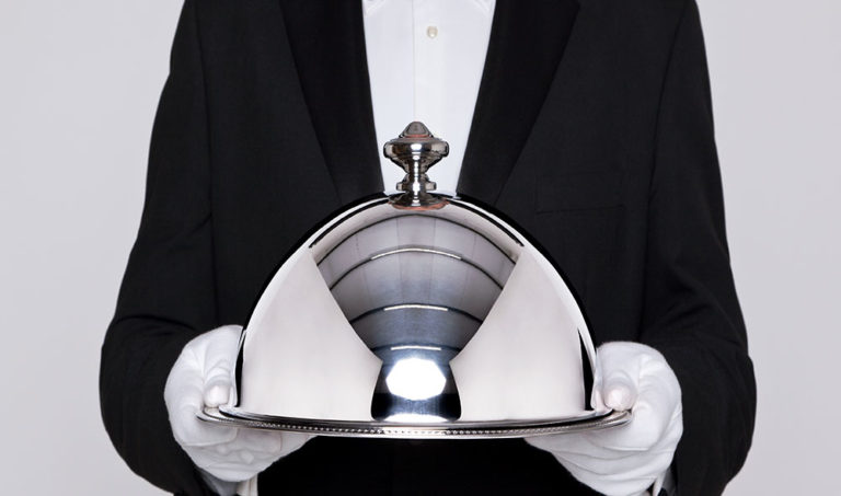 Fine dining waiter with a silver cloche